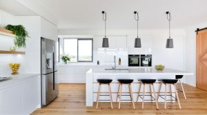 white kitchen with large island | Featured image for AQWA Constructions Kitchen Renovations blog.