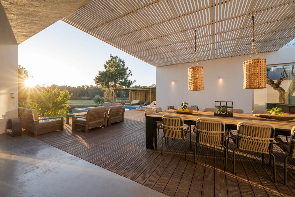Modern timber deck with chairs and a table | Featured image for Deck Builders Brisbane service page on AQWA Constructions.