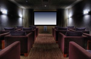 Photo of empty chairs in a luxurious home movie theatre | Featured image for the Home Theatre Ideas blog from AQWA Constructions.