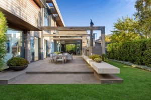 Photo of a modern backyard with lush green lawn | Featured image for Modern Landscaping Ideas blog by AQWA Constructions.